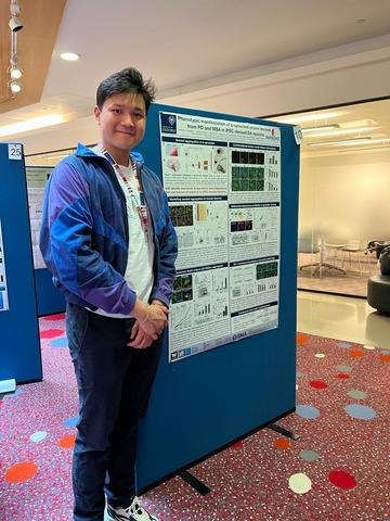 A photograph of Benedict Tanudjojo with his poster. A photograph of Benedict Tanudjojo with his poster.